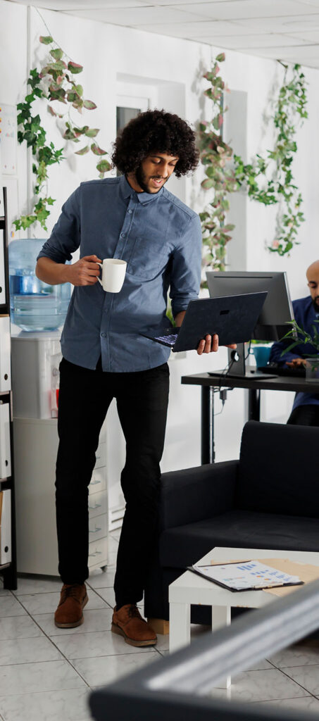 Business professional reviewing data analytics on tablet in modern office environment